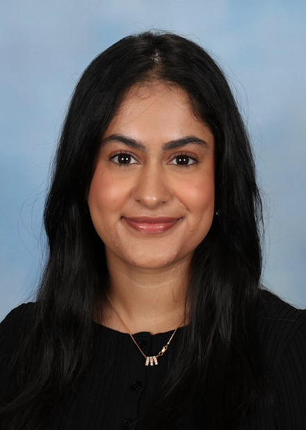Smiling woman with long dark hair against blue background