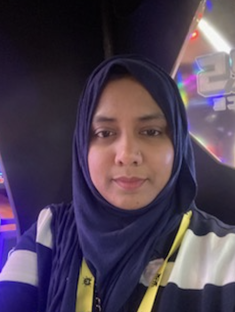 Person in a hijab at an arcade game