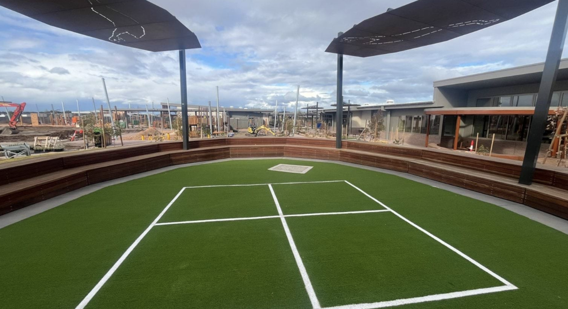 Outdoor seating area with artificial grass court