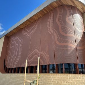 Building with decorative rust-coloured metal panels.