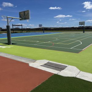 Outdoor basketball and sports courts under blue sky.
