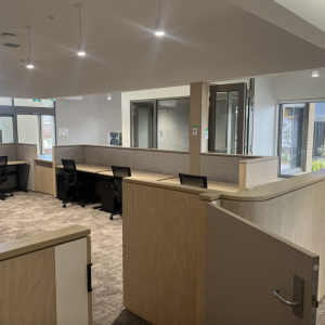 Modern office workspace with cubicles and chairs.